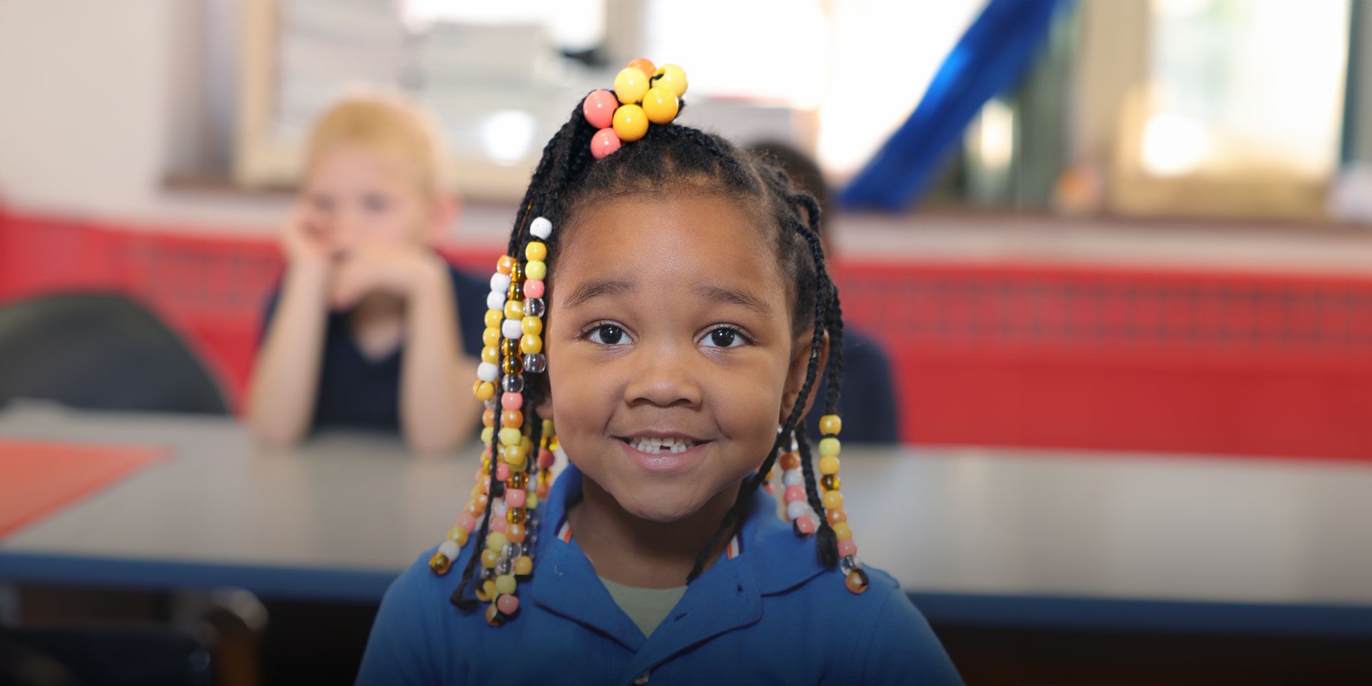 Smiling elementary student sitting at desk